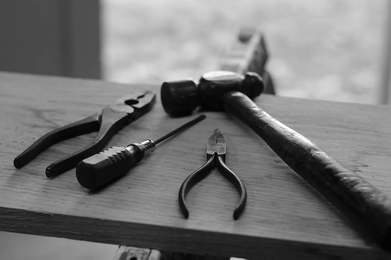 Hand tools laid out on a wooden workbench