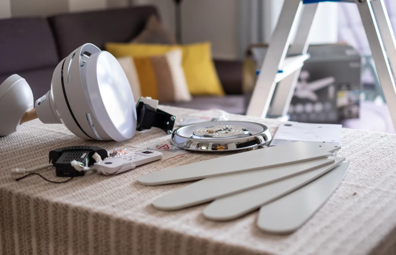 Ceiling fan parts laid out on a table before installation