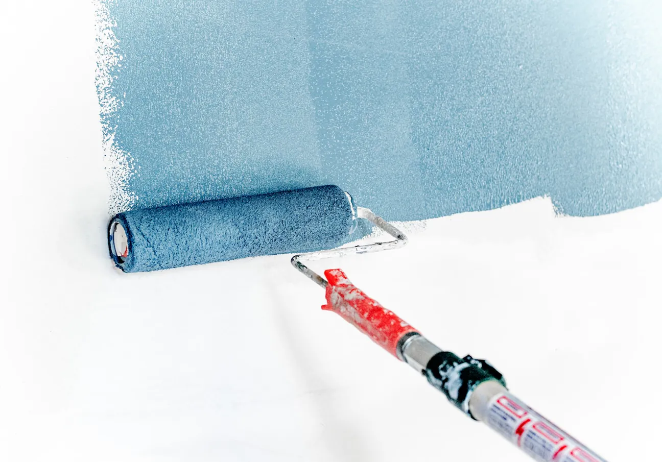 A roller laying down fresh paint